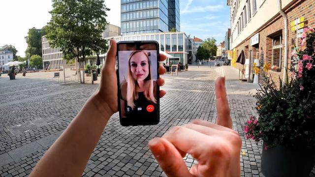 POV image of a deaf person using sign language to communicate via video chat on the smartphone.